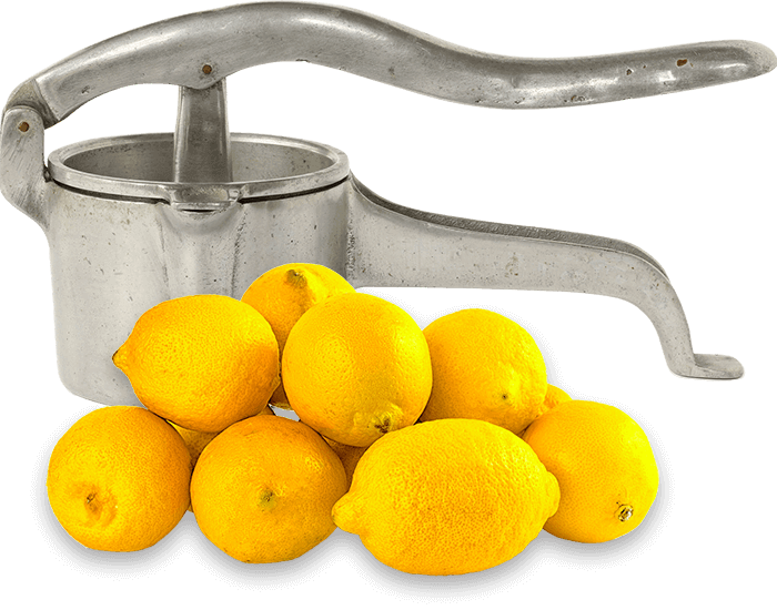 Old fashioned lemon press with fresh lemons